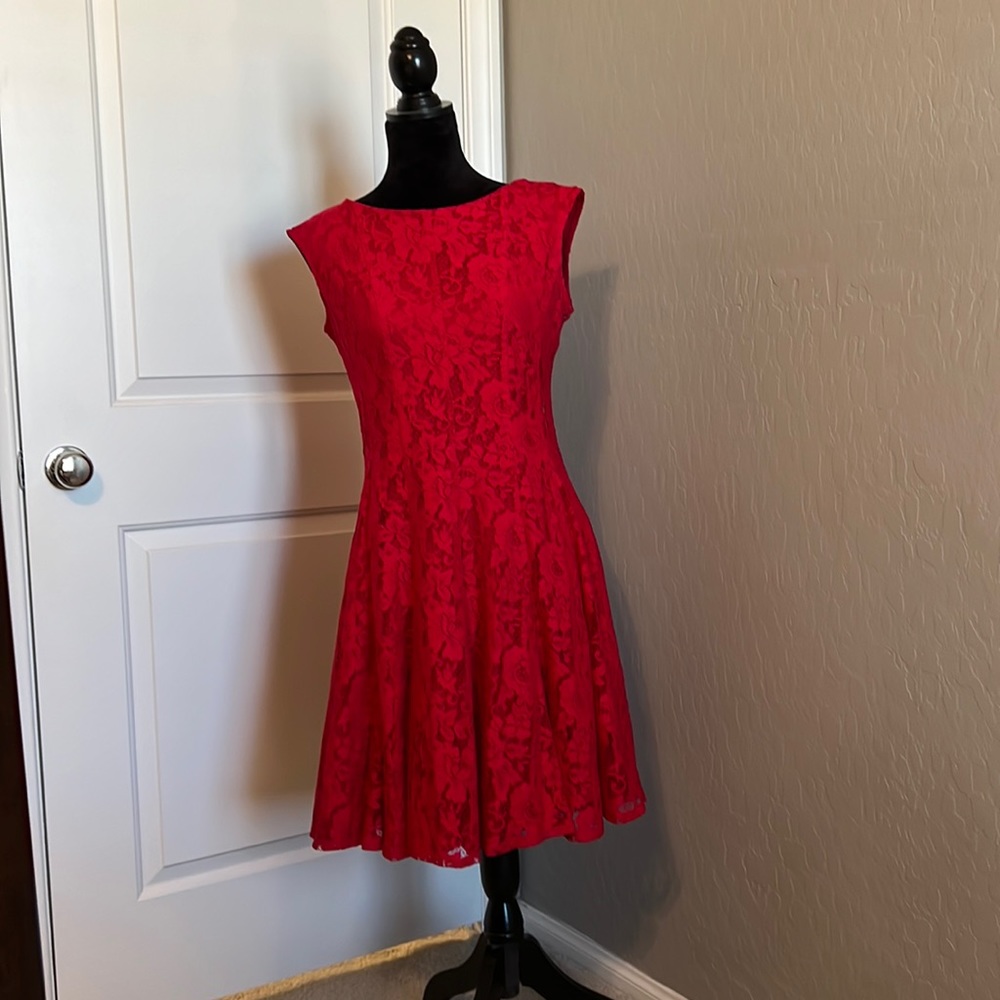 Red, sleeveless lace dress.